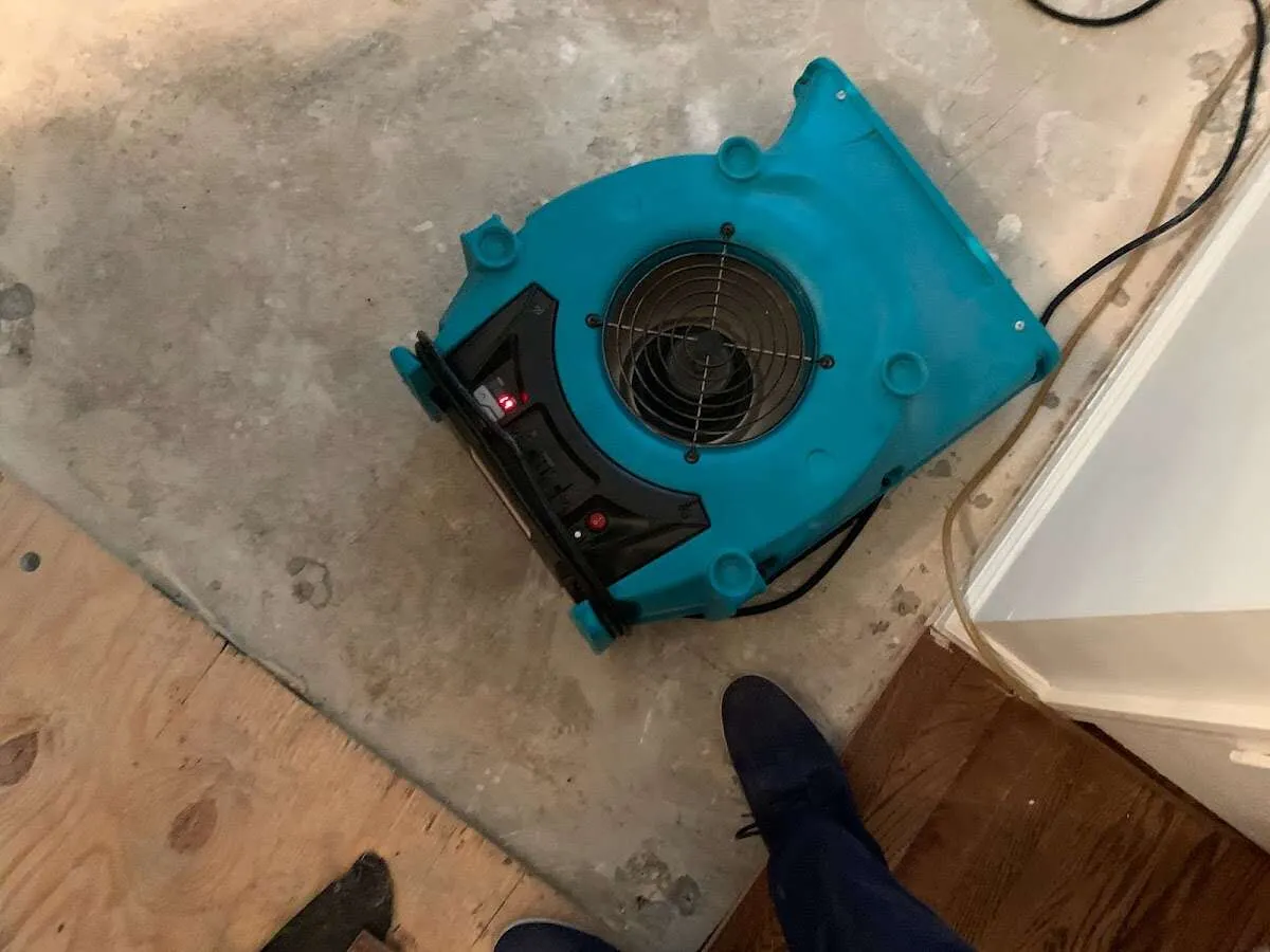 Air mover drying subfloor during Commercial Water Damage Restoration in Calimesa